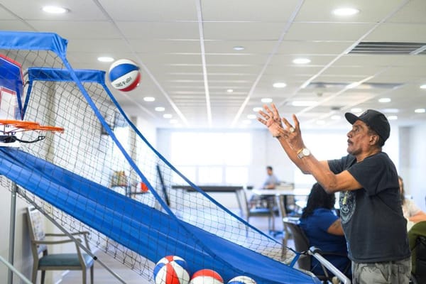 Resident playing basketball in a common area