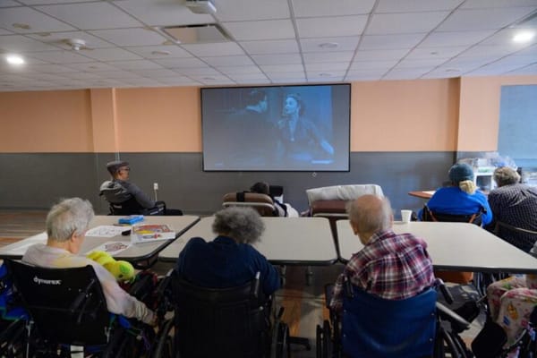Residents enjoying a movie in a common room