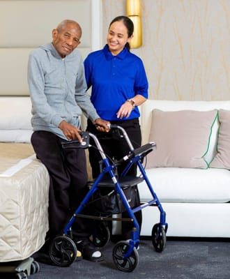 Staff assisting a resident in a bright room