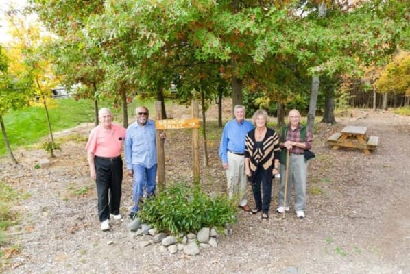 Residents enjoying an outdoor area with a sign
