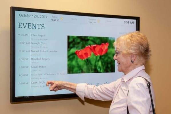 Senior resident engaging with event display