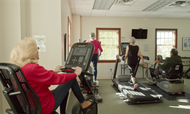 Residents exercising in a fitness area
