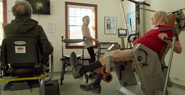 Residents engaging in fitness activity in a common room