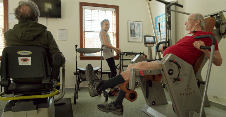 Residents engaging in fitness activity in a common room