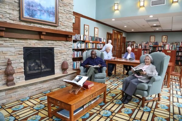 Residents reading in a cozy library setting
