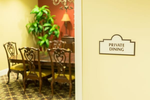 Private dining area with a large table and chairs