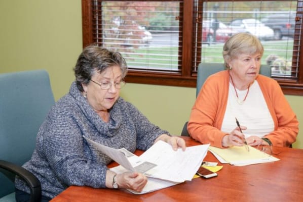 Two residents engaged in a discussion at a table