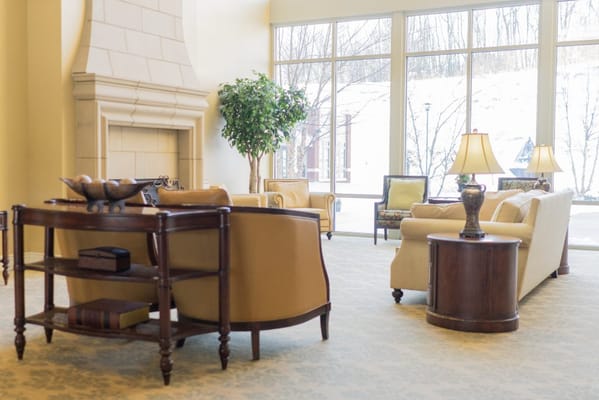 Bright common area with comfortable seating and windows