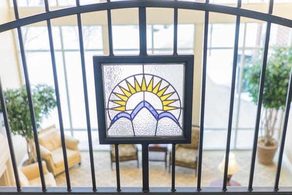 Stained glass window above a cozy common area