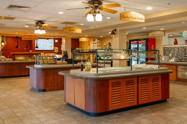 Bright dining area with salad bar and seating