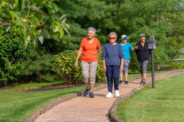 Residents walking on a path in a garden