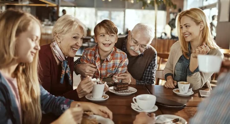 Residents and family enjoying time together in a cafe