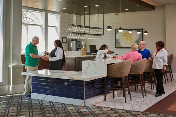 Residents and staff interacting in a dining area
