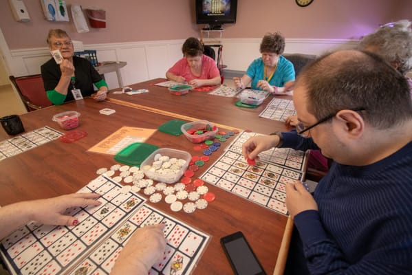 Residents engaged in a bingo game in a common area