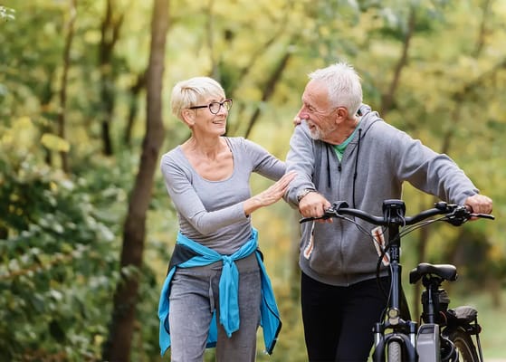 Two seniors enjoying a walk in a park setting