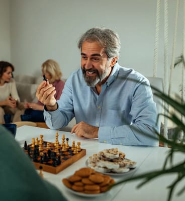 Residents enjoying a game of chess with snacks