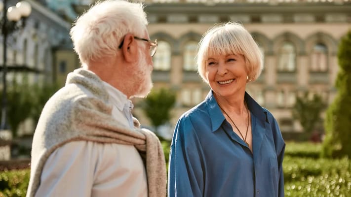 Two seniors enjoying a stroll in a park