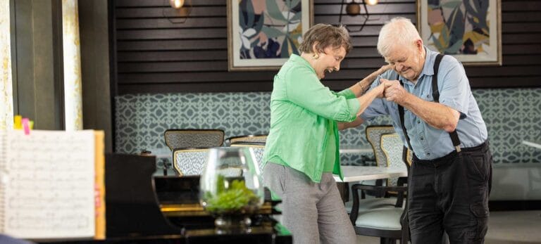 Residents dancing in a stylish common area