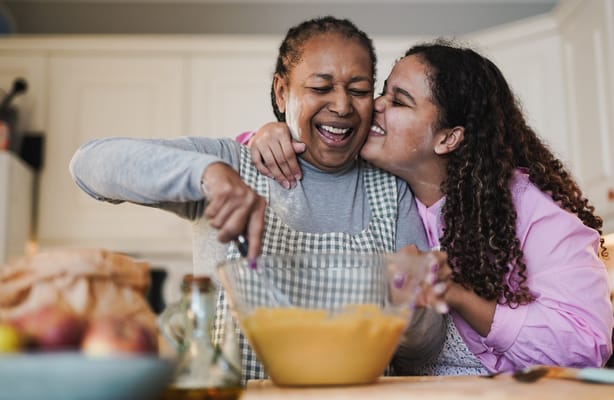 Residents cooking together in a warm kitchen
