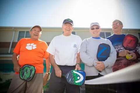 Seniors enjoying an outdoor activity with paddles