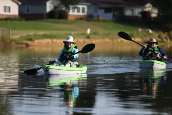 Residents kayaking on a tranquil lake