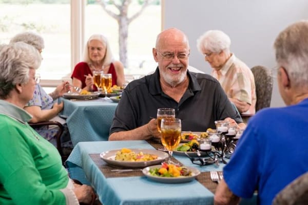 Residents enjoying a meal in the dining room