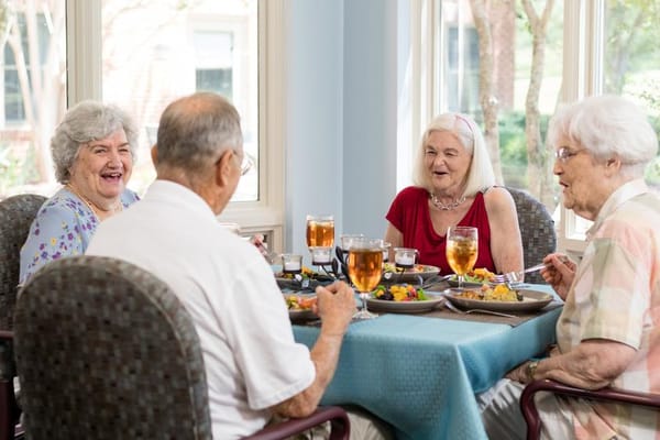 Residents enjoying a meal together in the dining room