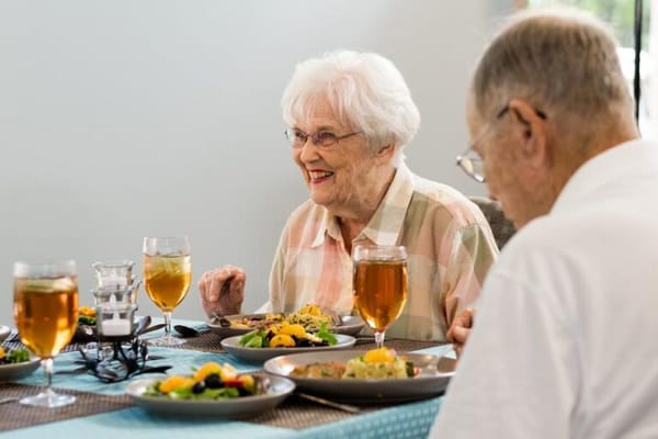 Residents enjoying a meal together in the dining room