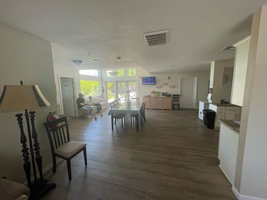 Light-filled common area with residents and a view outside
