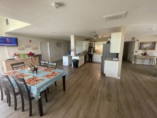 Bright dining area with a kitchen in a senior living facility