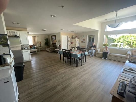 Bright common area with residents and seating