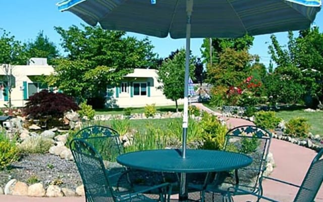 Outdoor seating area with tables and umbrellas