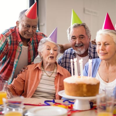 Residents celebrating with cake at a birthday party