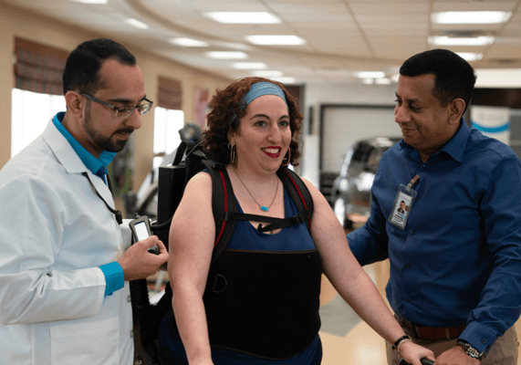 Staff assisting a resident with mobility equipment