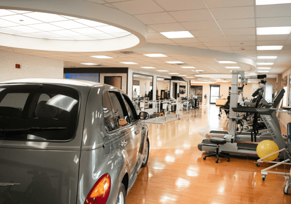 Interior fitness area with equipment and a vehicle
