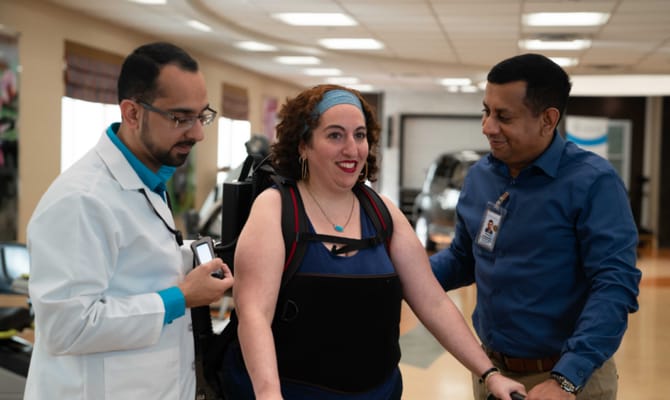 Staff assisting a resident during therapy session