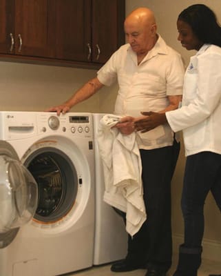 Staff assisting a resident with laundry tasks