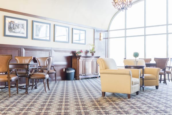 Bright lounge area with seating and large windows