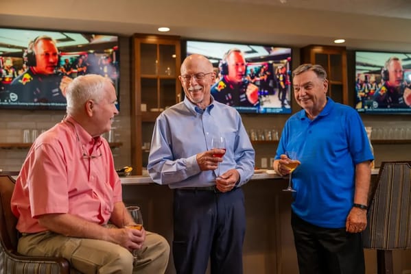 Residents enjoying drinks and conversation in a social area