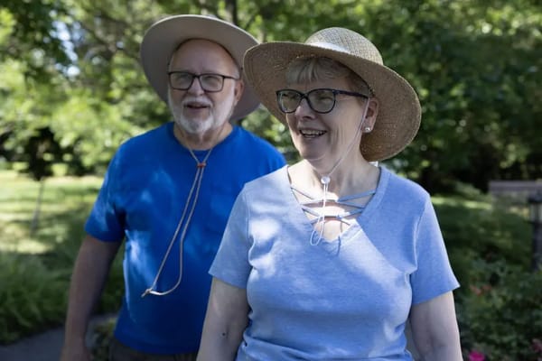 Couple smiling outdoors in the garden