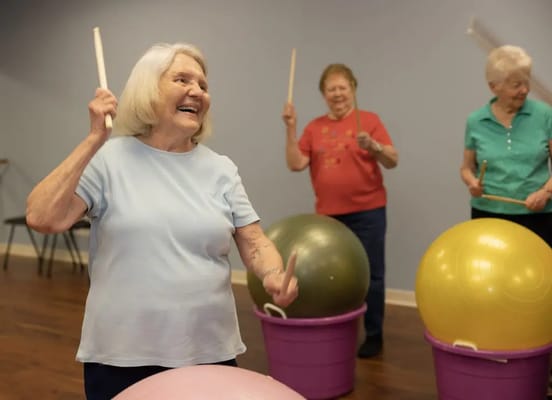 Residents enjoying a rhythmic activity in a communal space