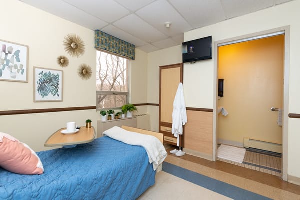 Cozy resident room with a bed and TV