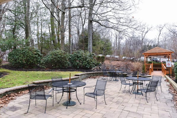 Outdoor seating area with tables and gazebo