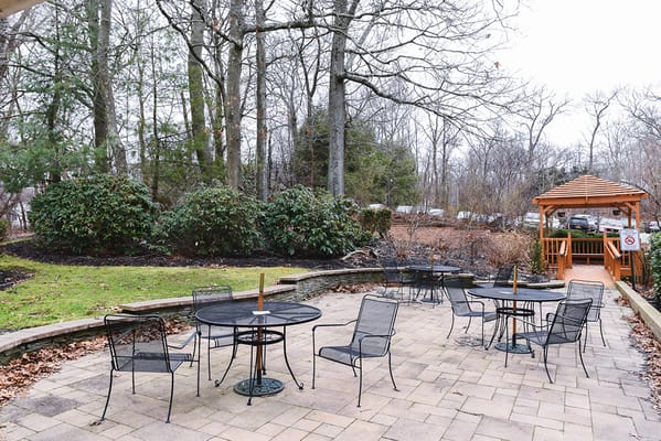 Outdoor seating area with tables and gazebo