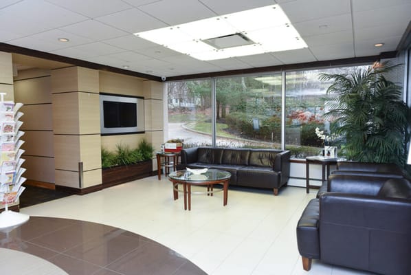 A modern lounge area with seating and plants