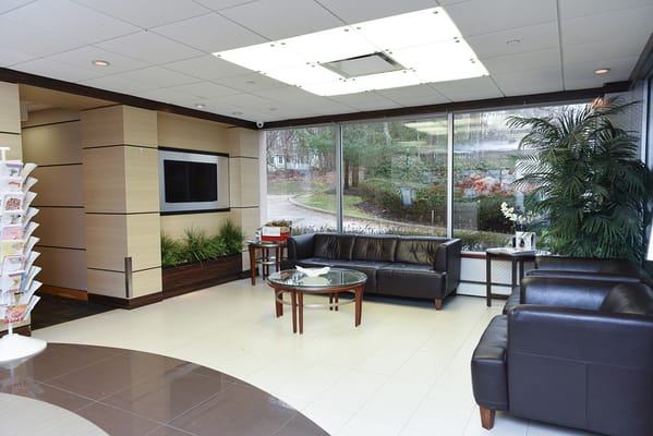 A modern lounge area with seating and plants