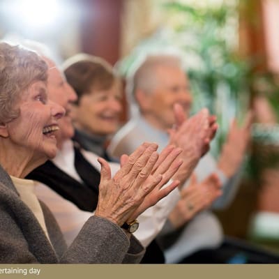 Residents enjoying an entertaining event with applause
