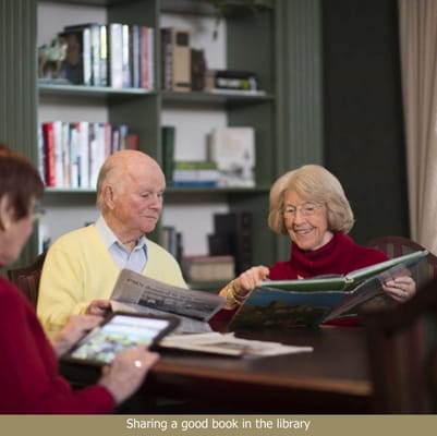 Two residents reading in the library