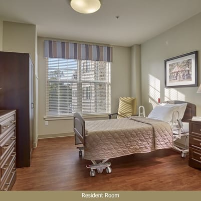 Cozy resident room with a bed and window view