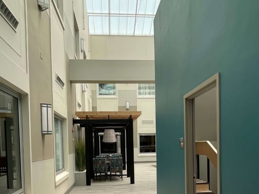 Interior walkway with seating area and bright lighting